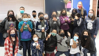 K-12 and college students posing for a photograph.