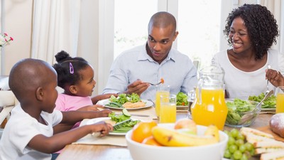 A family sits around the dinner table.