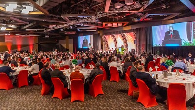 People in business attire attend a gala.