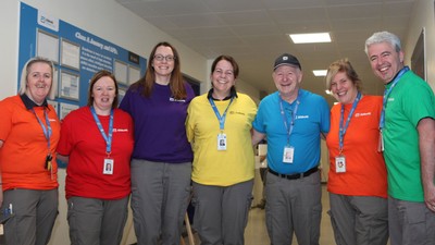 Employees wear Abbott T-shirts and lanyards.