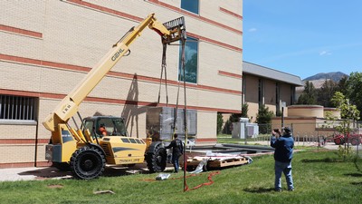 A crane lowers a scientific instrument.