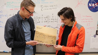 Students holding photograph.