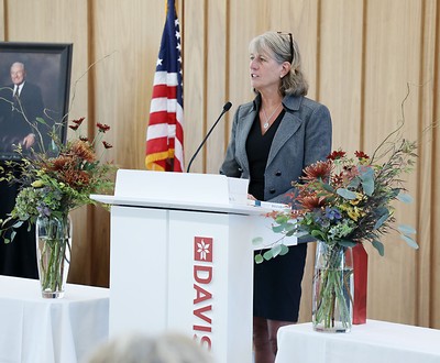 Noelle Cockett speaking at a podium.