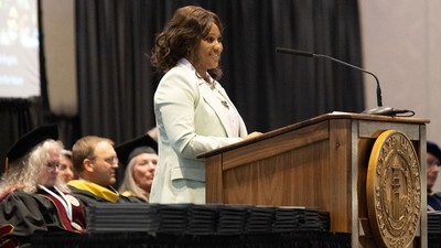Kosi Colin speaks from the podium.
