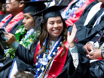 Graduate waves while seated