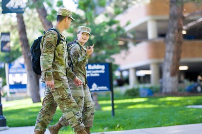 Students in military fatigues walking on the USU Logan campus.