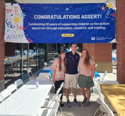 People standing in front of a banner reading "Congratulations ASSERT."