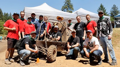 A team of engineering students and their off-road buggy.