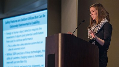 A woman speaking at a conference.