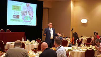 A man speaking at a conference.