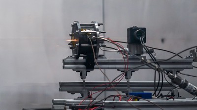 A small satellite propulsion device test firing.
