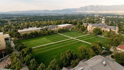 An aerial view of an American flag mowed into grass on USU Logan's Quad.