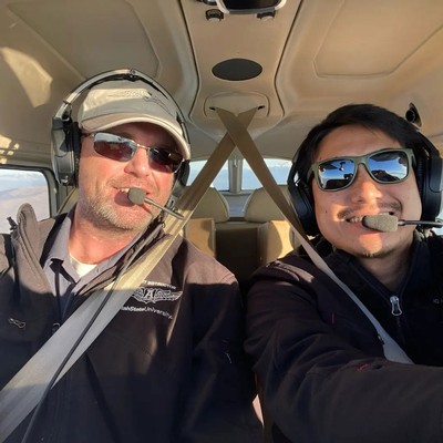 Two pilots in a small airplane.