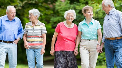 Older people walking along a path.