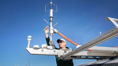 Randy Martin adjusting air quality instruments.