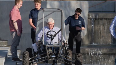 A man using a dune buggy.