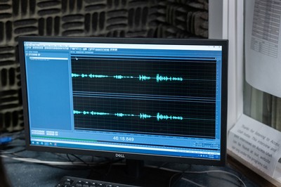 A computer displaying an audio editing program.