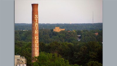 A smokestack with brick letters spelling "state college."