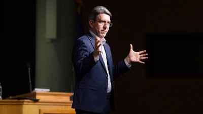 A man addresses a crowd.