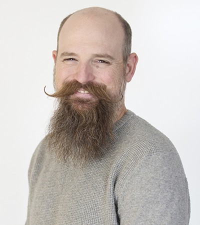 A man poses for a headshot.
