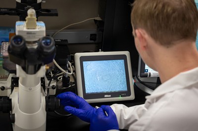 A researcher using a microscope.