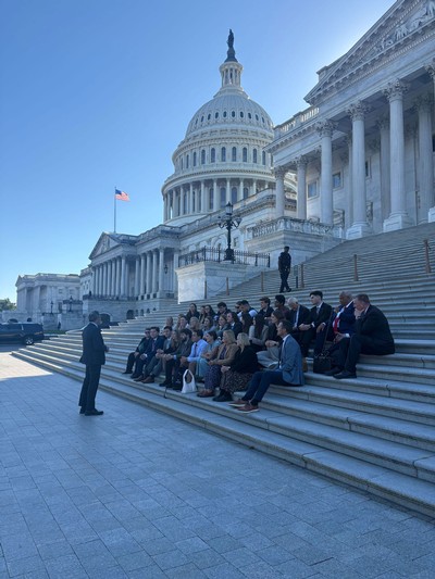 Students sitting on steps outside the U.S. Capitol.
