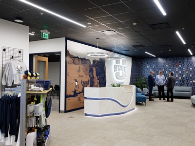 A desk, kiosk with merchandise and a logo of Utah State Eastern.