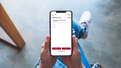 A person holding a mobile phone with a survey about e-cigarette usage on it.