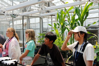 Children in a greenhouse.