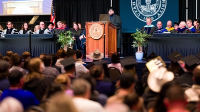 A student delivers a speech at a commencement ceremony.