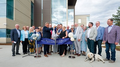 A crowd of people at a ribbon-cutting ceremony.