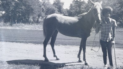 Julie Chugg Palfreyman holding a horse's bridle.