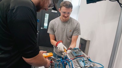 People working on an electric vehicle battery.