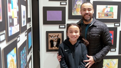 Student presenting their art at the Student Art Exhibition