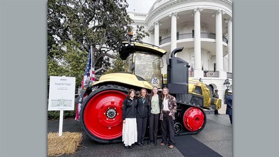 Students in front of a tractor in front of the White House.