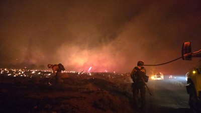 Firefighters fighting a wildfire.