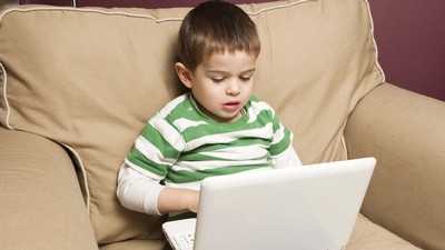 A child using a laptop.