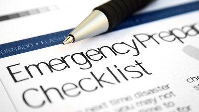 A pen sits atop a document that says "Emergency Preparedness Checklist."