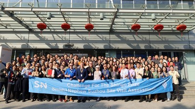 A group photo of employees outside a business facility. Text reads: Challenge for the Shingo Prize.