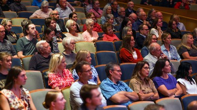 People seated in theater chairs.