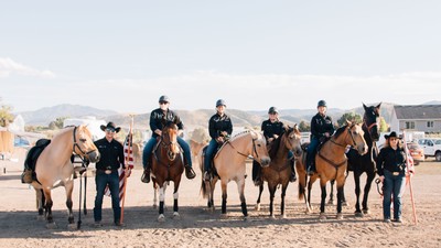 People on horseback with American flags.
