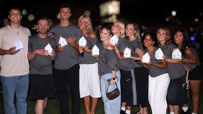 USU Eastern students holding lanterns shaped like the Block A.