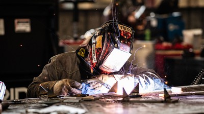 A person in a mask welding.