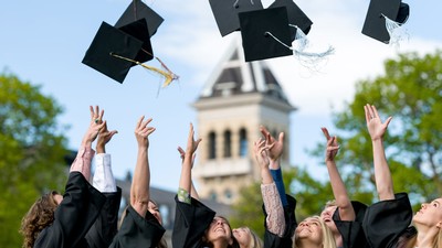 Graduates throwing their hats in the air.
