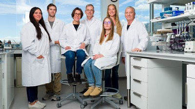 Researchers in lab coats posing for a group photo.