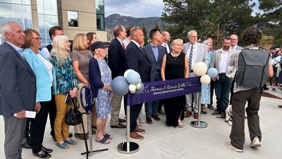 A crowd of people at a ribbon-cutting ceremony.