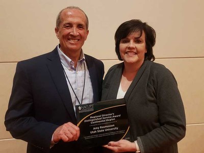 Amy Rasmussen receiving award from Cordell Briggs.