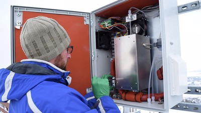 Tyler Elgiar makes an adjustment to the analyzer.