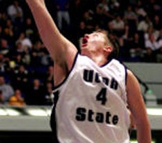 A USU men's basketball team member in action