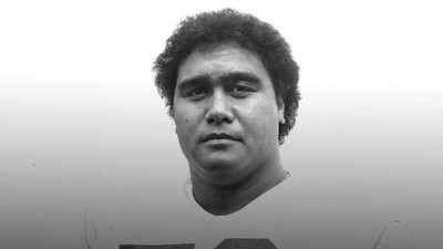 A black and white photo of a former USU athlete.